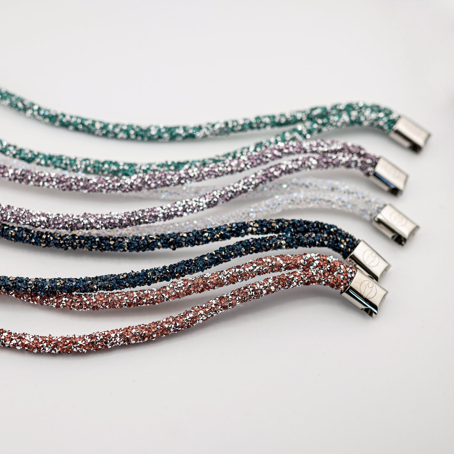 Horse browband Spectrum browband by IBV Equine
Experience a new dimension of browband design. Crafted with a pair of soft,
flexible tubes, each generously sprinkled with dazzling rhinestones, this piece offers a unique texture and radiant sparkle. An internal metal wire allows for effortless shaping, ensuring a perfect contour to your horse's brow and maintaining its elegant form.
Each browband is handmade from scratch using premium European materials and durable leather. Featuring our exclusive magn