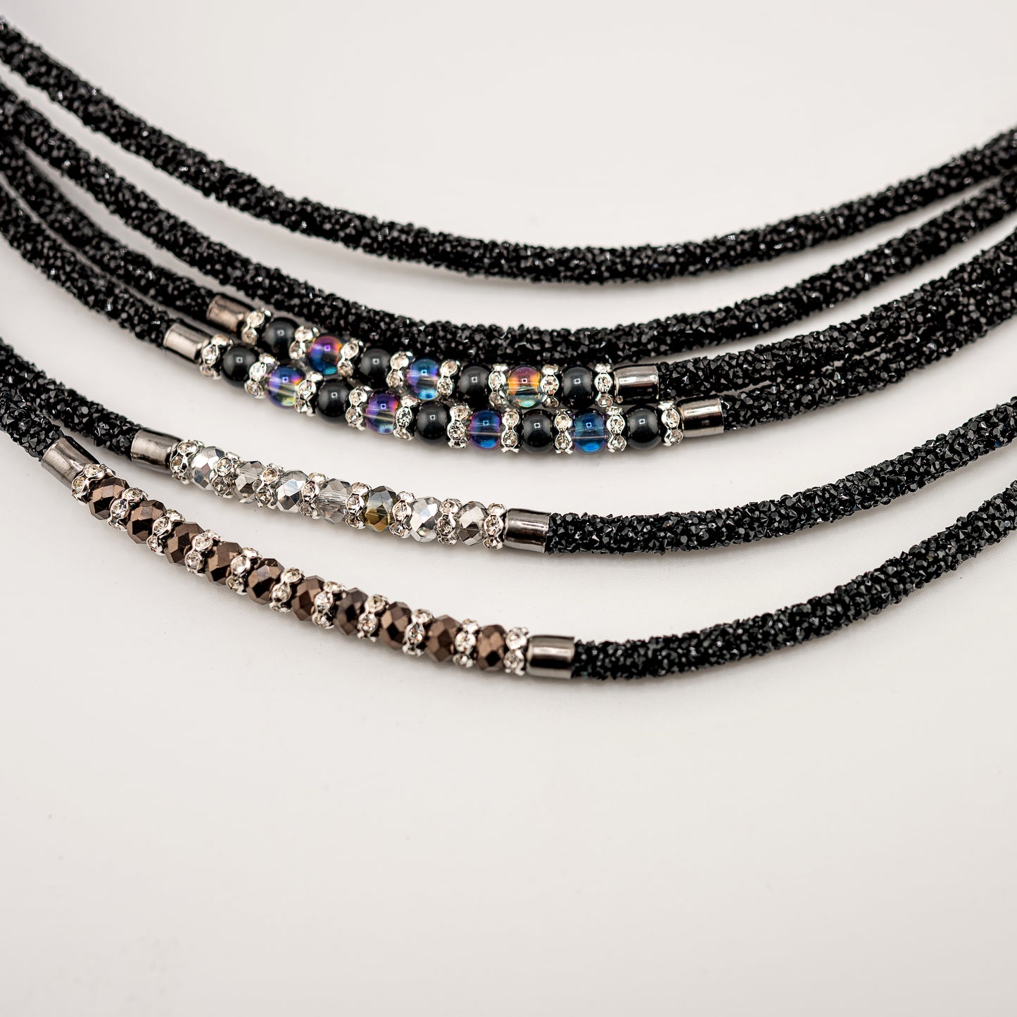 Horse browband Spectrum Double with beads browband by IBV Equine
Experience a new dimension of browband design. Crafted with a pair of soft,
flexible tubes, each generously sprinkled with dazzling rhinestones, this piece offers a unique texture and radiant sparkle. An internal metal wire allows for effortless shaping, ensuring a perfect contour to your horse's brow and maintaining its elegant form.
Each browband is handmade from scratch using premium European materials and durable leather. Featuring o