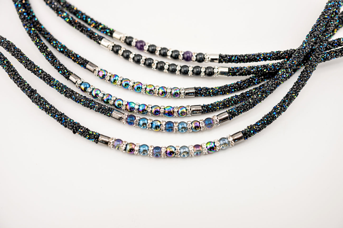 Horse browband Spectrum Double with beads browband by IBV Equine
Experience a new dimension of browband design. Crafted with a pair of soft,
flexible tubes, each generously sprinkled with dazzling rhinestones, this piece offers a unique texture and radiant sparkle. An internal metal wire allows for effortless shaping, ensuring a perfect contour to your horse's brow and maintaining its elegant form.
Each browband is handmade from scratch using premium European materials and durable leather. Featuring o