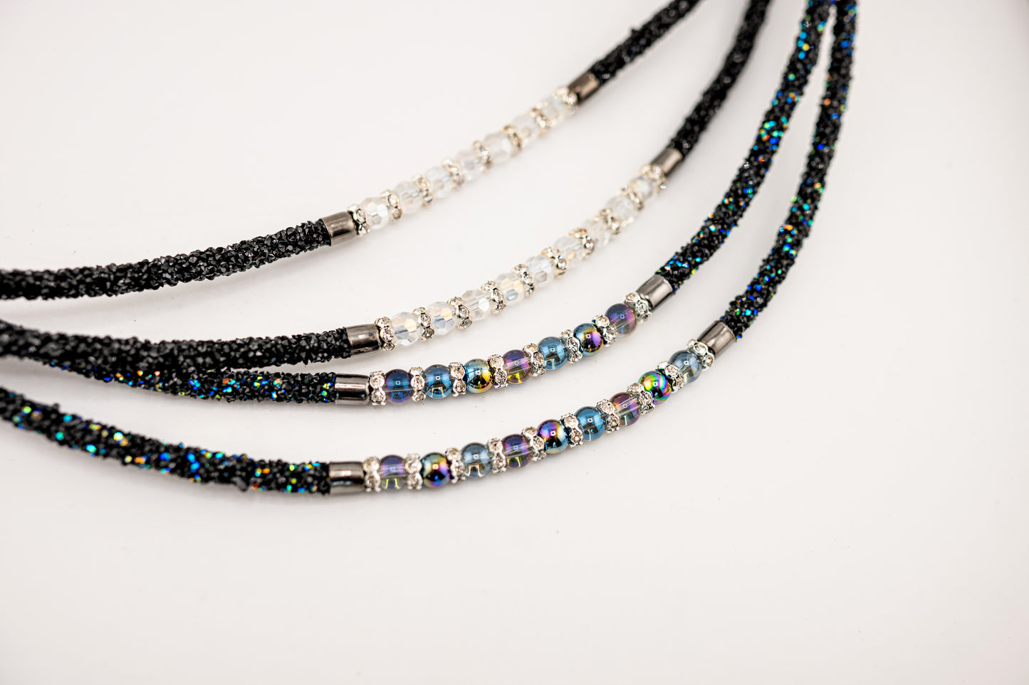 Horse browband Spectrum Double with beads browband by IBV Equine
Experience a new dimension of browband design. Crafted with a pair of soft,
flexible tubes, each generously sprinkled with dazzling rhinestones, this piece offers a unique texture and radiant sparkle. An internal metal wire allows for effortless shaping, ensuring a perfect contour to your horse's brow and maintaining its elegant form.
Each browband is handmade from scratch using premium European materials and durable leather. Featuring o