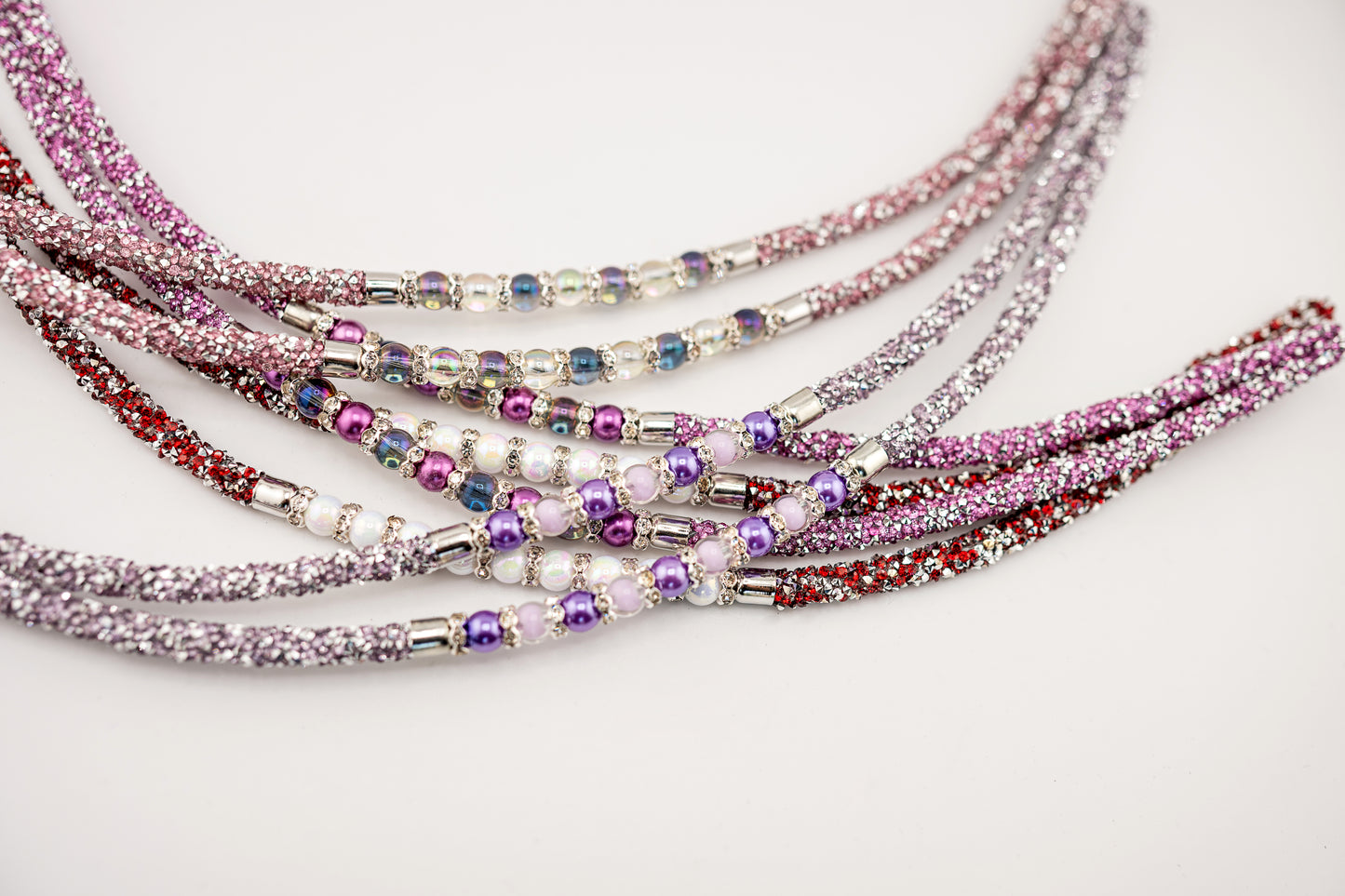 Horse browband Spectrum Double with beads browband by IBV Equine
Experience a new dimension of browband design. Crafted with a pair of soft,
flexible tubes, each generously sprinkled with dazzling rhinestones, this piece offers a unique texture and radiant sparkle. An internal metal wire allows for effortless shaping, ensuring a perfect contour to your horse's brow and maintaining its elegant form.
Each browband is handmade from scratch using premium European materials and durable leather. Featuring o