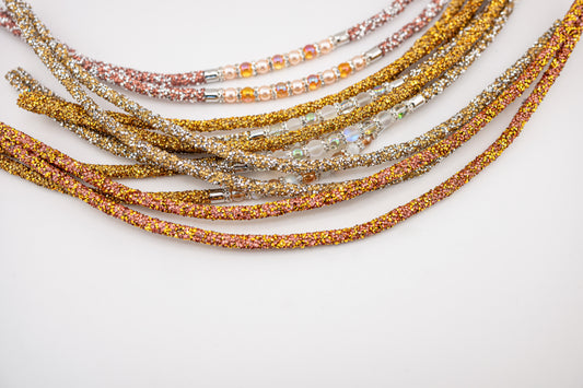 Horse browband Spectrum Double with beads browband by IBV Equine
Experience a new dimension of browband design. Crafted with a pair of soft,
flexible tubes, each generously sprinkled with dazzling rhinestones, this piece offers a unique texture and radiant sparkle. An internal metal wire allows for effortless shaping, ensuring a perfect contour to your horse's brow and maintaining its elegant form.
Each browband is handmade from scratch using premium European materials and durable leather. Featuring o