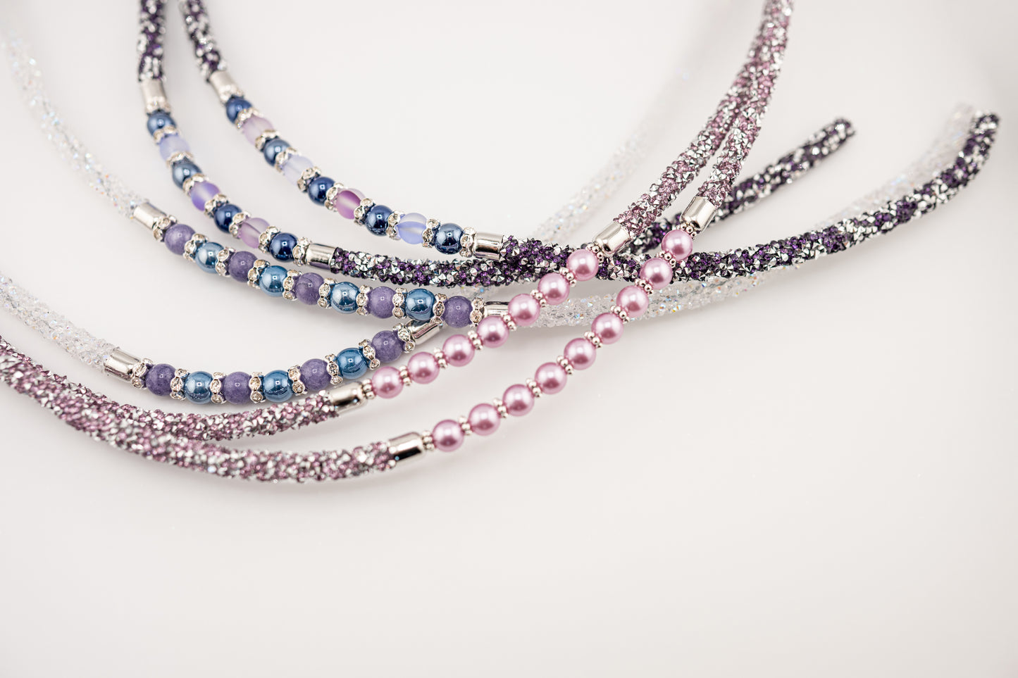 Horse browband Spectrum Double with beads browband by IBV Equine
Experience a new dimension of browband design. Crafted with a pair of soft,
flexible tubes, each generously sprinkled with dazzling rhinestones, this piece offers a unique texture and radiant sparkle. An internal metal wire allows for effortless shaping, ensuring a perfect contour to your horse's brow and maintaining its elegant form.
Each browband is handmade from scratch using premium European materials and durable leather. Featuring o