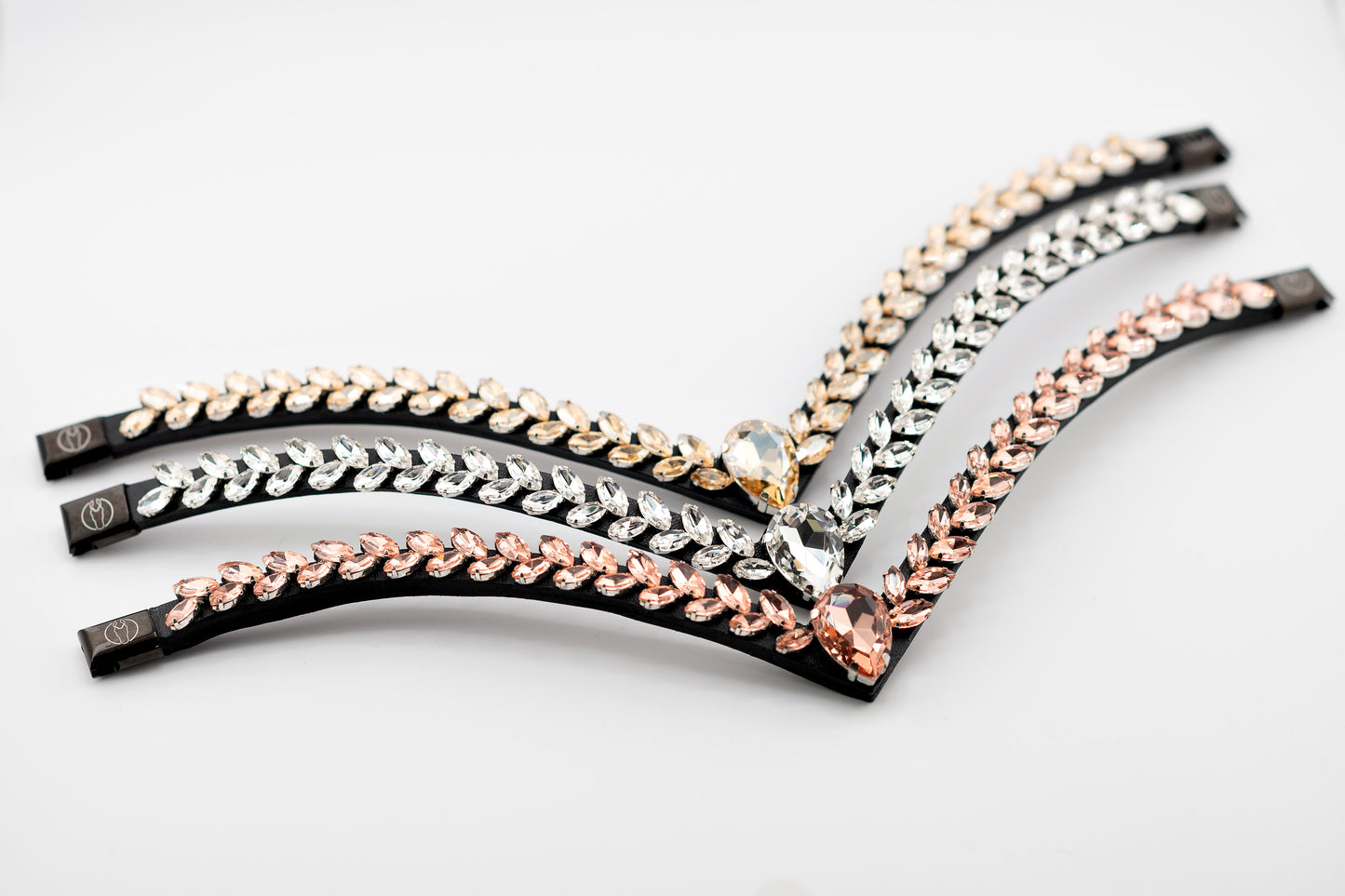 Horse browband Regalia browband by IBV Equine
Experience a new dimension of browband design. Caesar collection browband is a testament to ancient elegance reimagined for modern equestrianism. Its distinctive V-shape features meticulously placed, leaf-like added a large stone in the center for emphasis radiant sparkle.
Each browband is handmade from scratch using premium European materials and durable leather. Featuring our exclusive magnetic snap system,