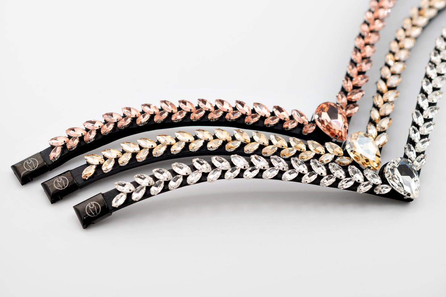 Horse browband Regalia browband by IBV Equine
Experience a new dimension of browband design. Caesar collection browband is a testament to ancient elegance reimagined for modern equestrianism. Its distinctive V-shape features meticulously placed, leaf-like added a large stone in the center for emphasis radiant sparkle.
Each browband is handmade from scratch using premium European materials and durable leather. Featuring our exclusive magnetic snap system,