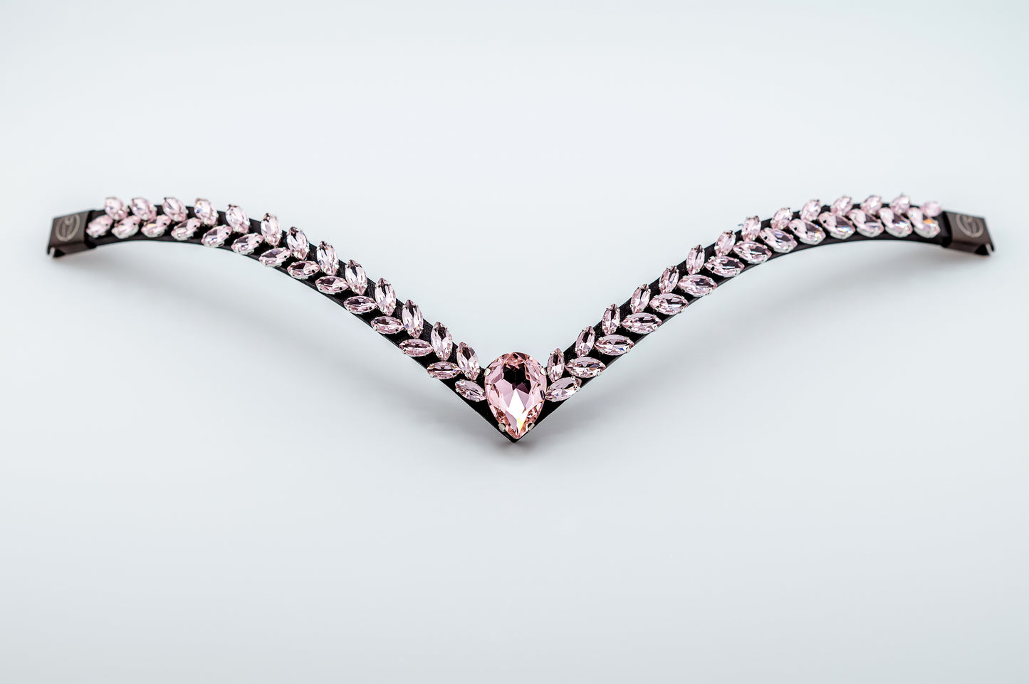 Horse browband Regalia browband by IBV Equine
Experience a new dimension of browband design. Caesar collection browband is a testament to ancient elegance reimagined for modern equestrianism. Its distinctive V-shape features meticulously placed, leaf-like added a large stone in the center for emphasis radiant sparkle.
Each browband is handmade from scratch using premium European materials and durable leather. Featuring our exclusive magnetic snap system,