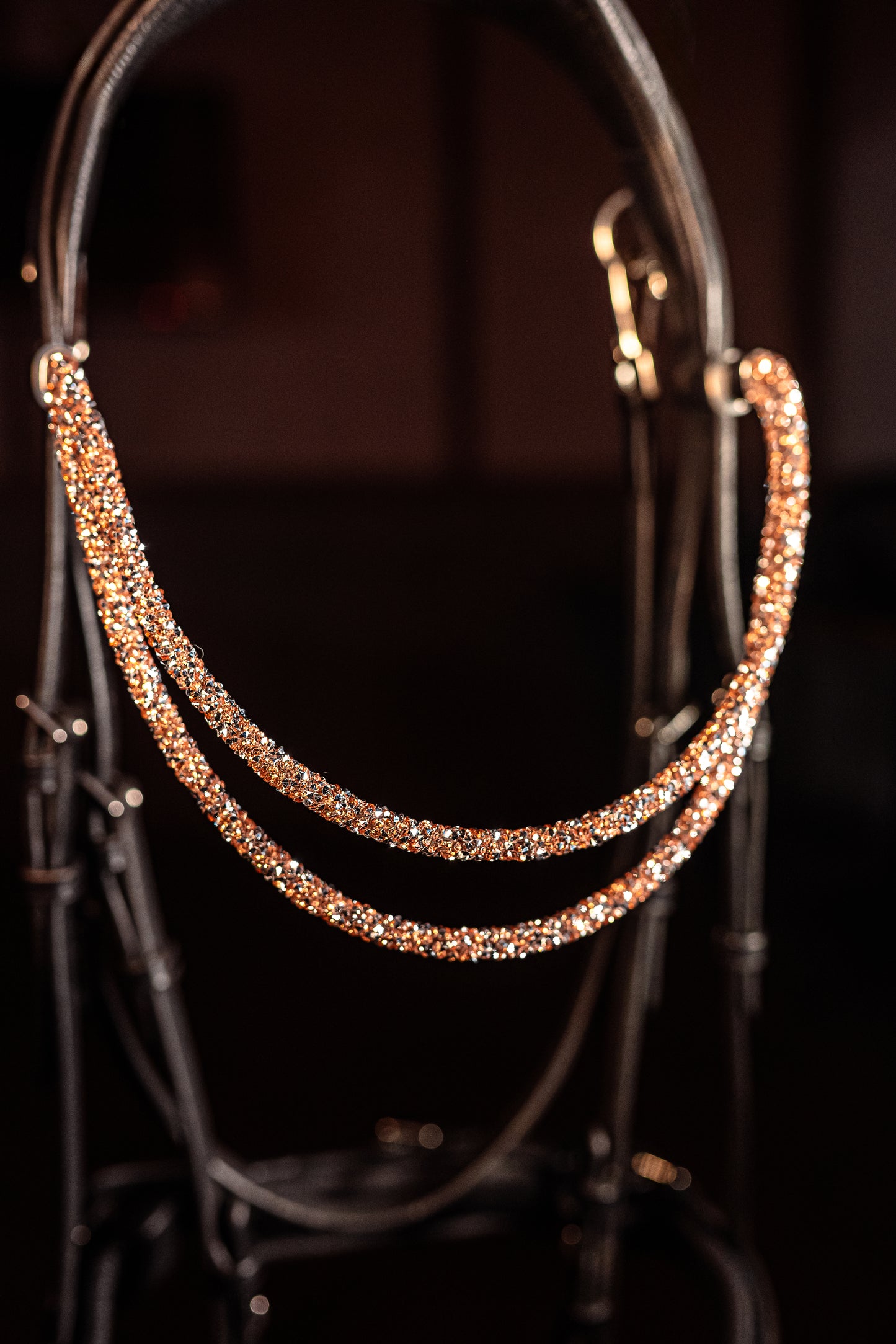 Experience a new dimension of browband design. Crafted with three soft, flexible tubes, each generously sprinkled with dazzling rhinestones, this piece offers a unique texture and radiant sparkle. An internal metal wire allows for effortless shaping, ensuring a perfect contour to your horse's brow and maintaining its elegant form.
Each browband is handmade from scratch using premium European materials and durable leather. Featuring our exclusive magnetic snap
