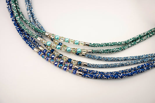 Horse browband Spectrum Double with beads browband  by IBV Equine
Experience a new dimension of browband design. Crafted with a pair of soft,
flexible tubes, each generously sprinkled with dazzling rhinestones, this piece offers a unique texture and radiant sparkle. An internal metal wire allows for effortless shaping, ensuring a perfect contour to your horse's brow and maintaining its elegant form.
Each browband is handmade from scratch using premium European materials and&nbsp;durable leather. Featuring o