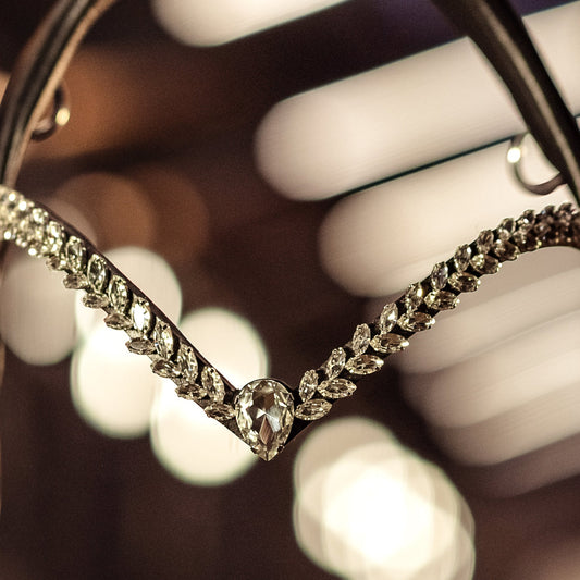 Horse browband Regalia White browband  by IBV Equine
Experience a new dimension of browband design. Caesar collection browband is a testament to ancient elegance reimagined for modern equestrianism. Its distinctive V-shape features meticulously placed, leaf-like added a large stone in the center for emphasis radiant sparkle. 
Each browband is handmade from scratch using premium European materials and durable leather. Featuring our exclusive magnetic snap system